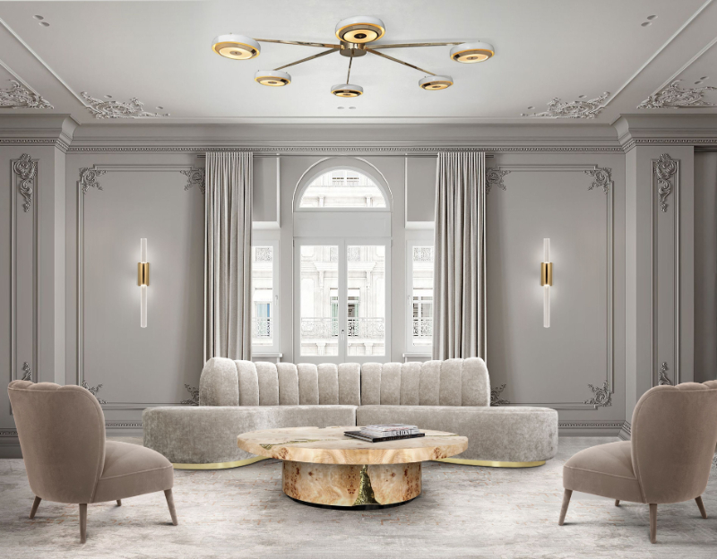 Grey sofa with gold details, marble poplar root coffee table, nude armchairs, grey tones in a living room