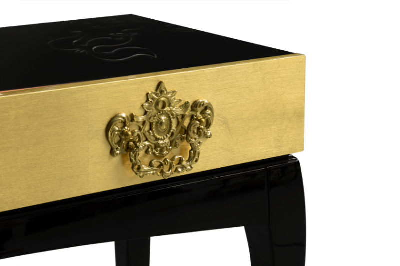 contemporary black and golden luxury console with drawers and gold details