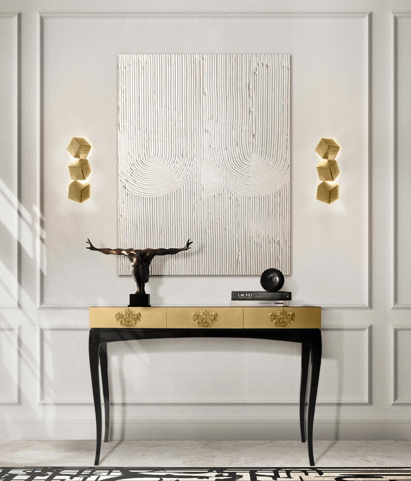 contemporary black and gold luxury console with drawers on a white wall with golden lamps and black and white rug